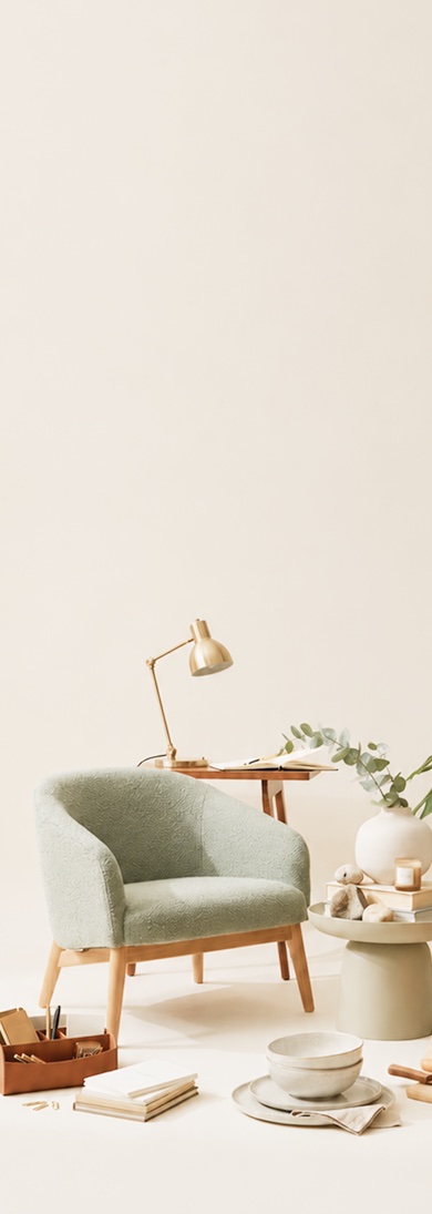 A cozy armchair and reading nook styled with NavaHome furniture